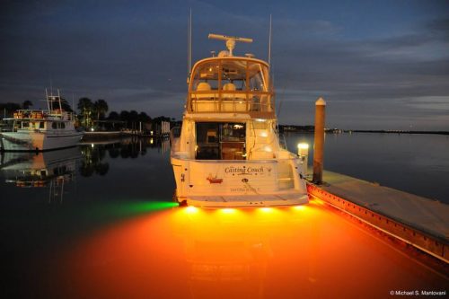 Fishing boat moored in harbour showing orange LEDs