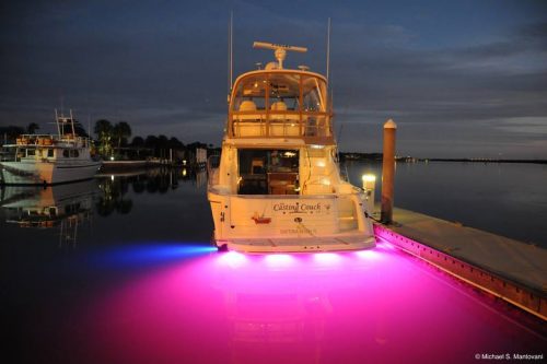 Fishing boat moored in harbour showing pink LEDs