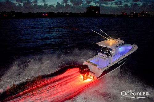 Fishing boat at speed showing red LEDs behind and blue LEDs on deck