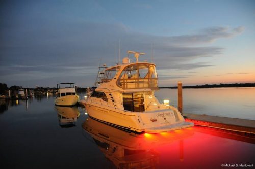 Fishing boat moored in harbour at sunrise showing red LEDs