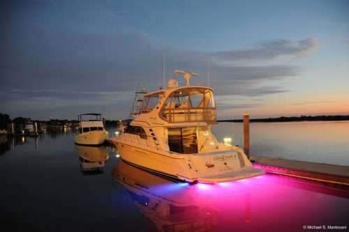 Fishing boat moored in harbour showing pink LEDs