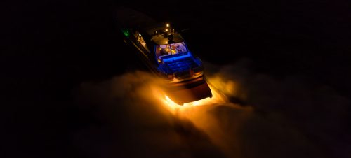 Colours behind a speedboat at night