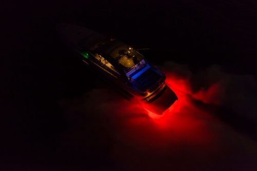 A boat travelling in the dark using the red LED light