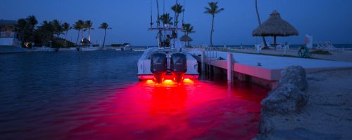 A long shot of a speed boat using a red led light