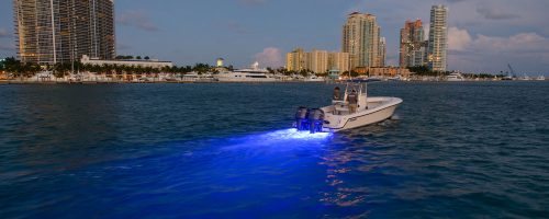 A landscape photo of a boat using a blue led light