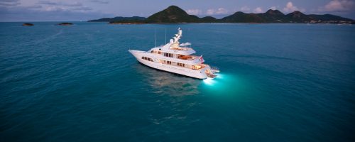 A boat in the middle of the sea using a blue led light